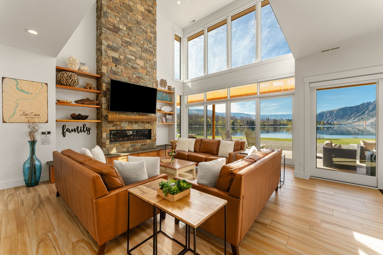 Living Room with Floor to Ceiling Views with sliding glass doors out to the covered patio, vaulted ceilings, gas fireplace, leather couches and a large TV with Roku to stream your favorite shows.