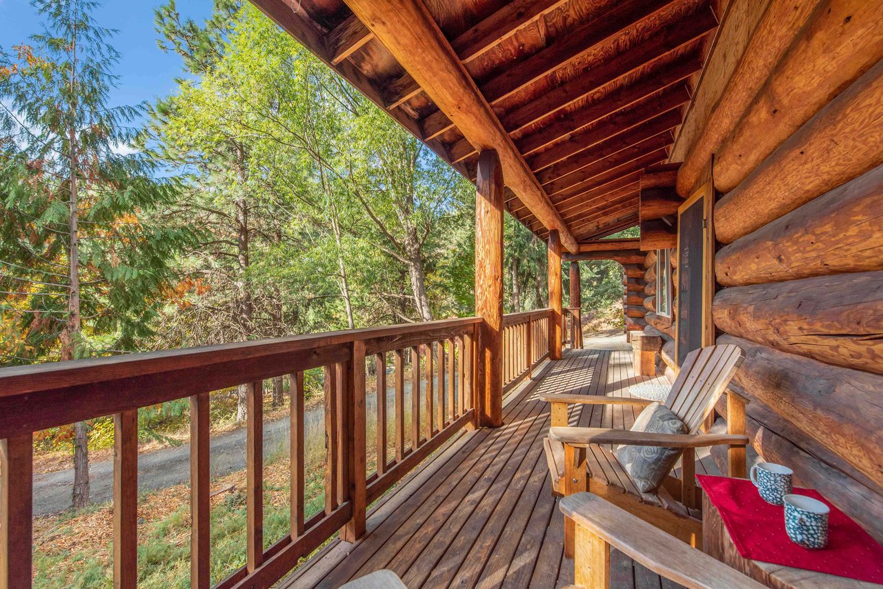 Log Cabin with a large covered porch